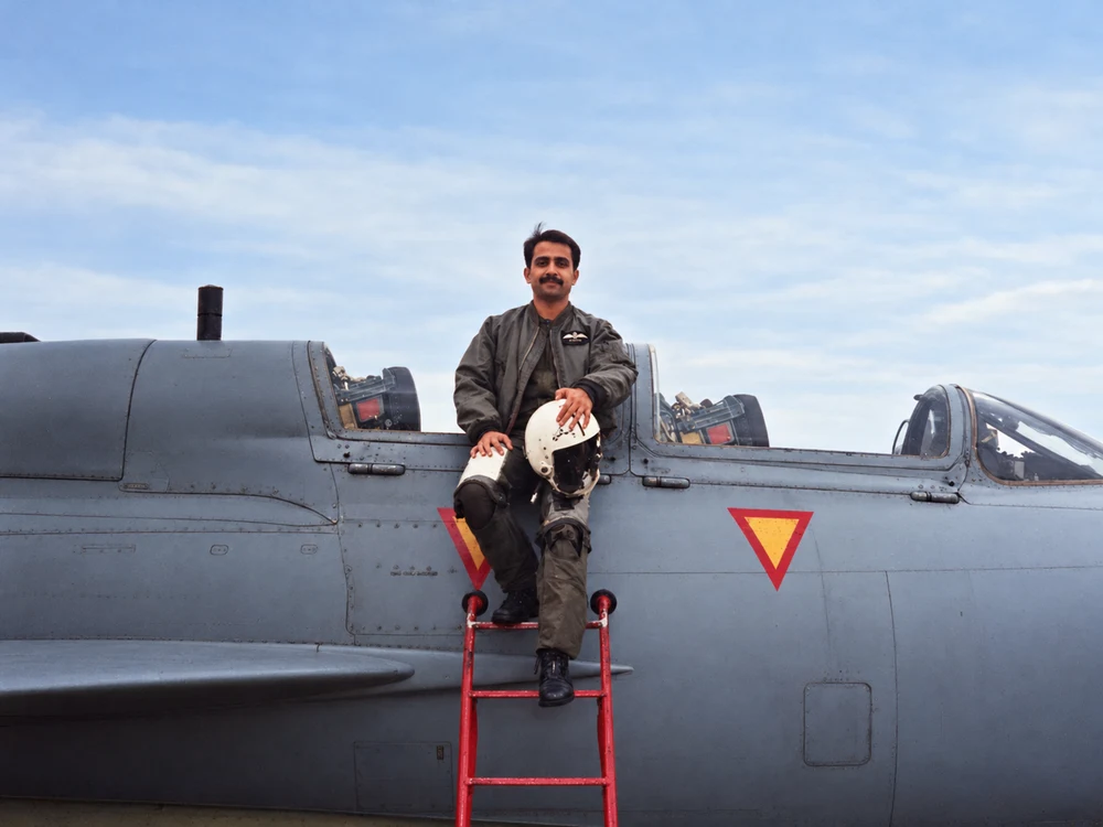 Umar Rafi in flying gear beside an aircraft in his early flying years