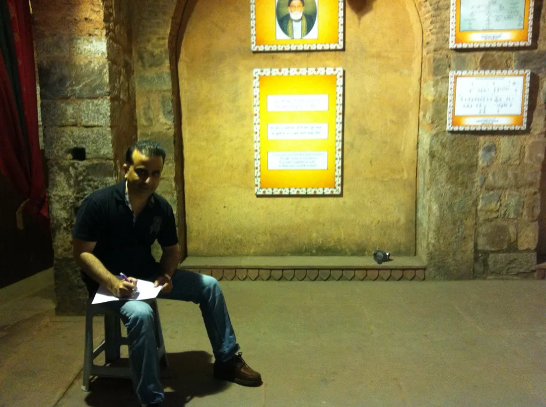 Umar Rafi writing inside Ghalib’s historic home in Old Delhi